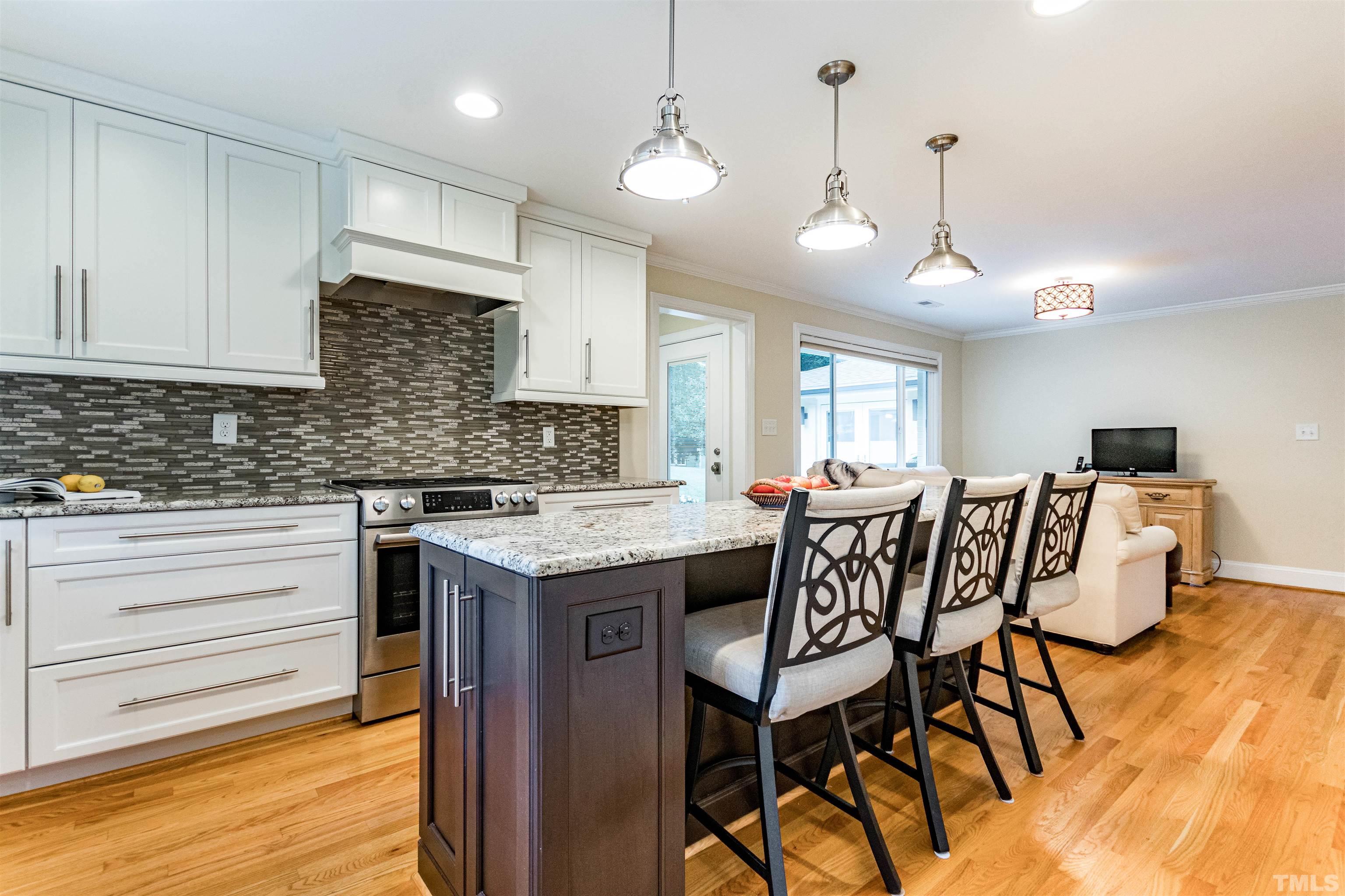 1509 Lutz Avenue Raleigh, NC 27607 - Photo 14 of 30 a kitchen with a table chairs stove and cabinets
