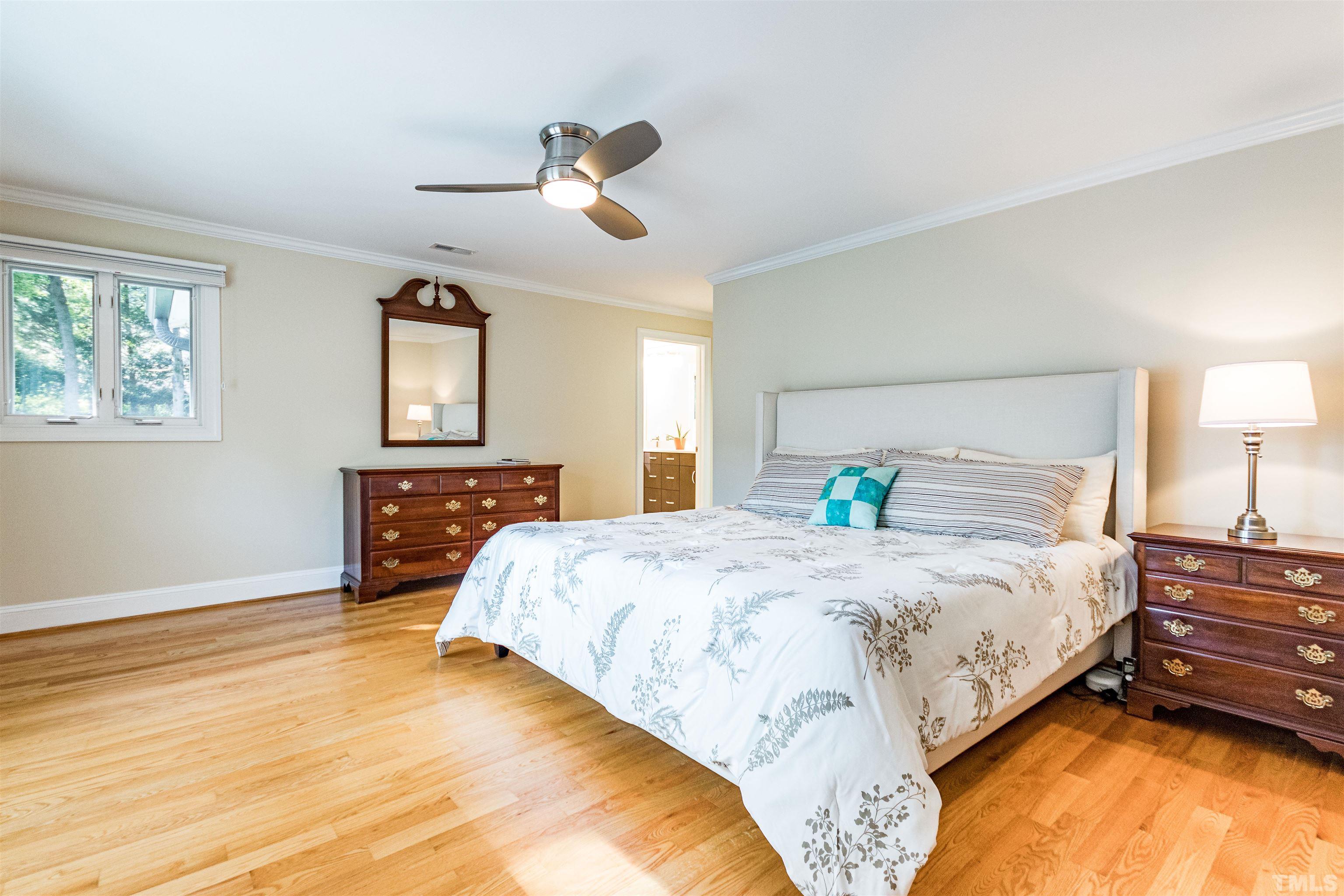 1509 Lutz Avenue Raleigh, NC 27607 - Photo 17 of 30 a bedroom with a bed and a dresser