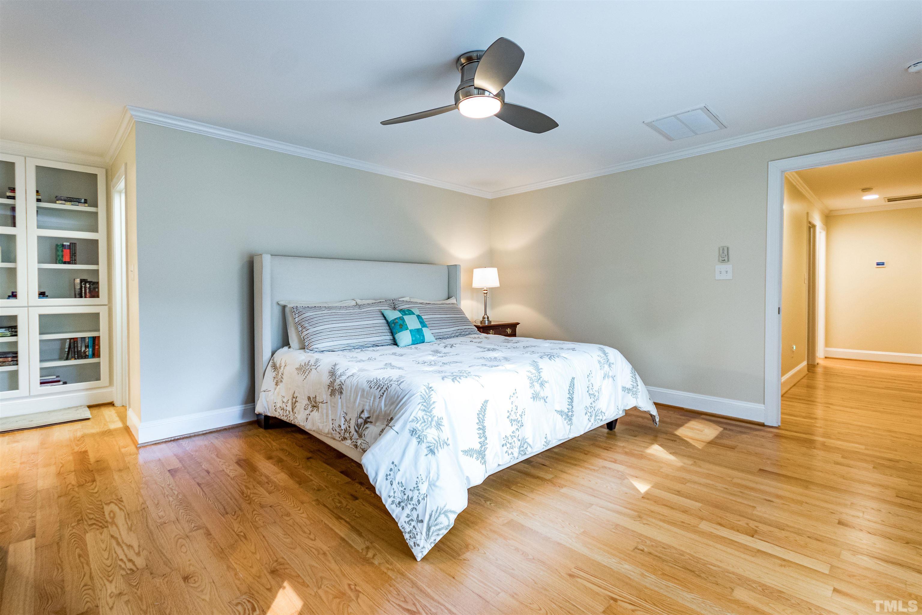 1509 Lutz Avenue Raleigh, NC 27607 - Photo 18 of 30 a bedroom with a bed and wooden floor
