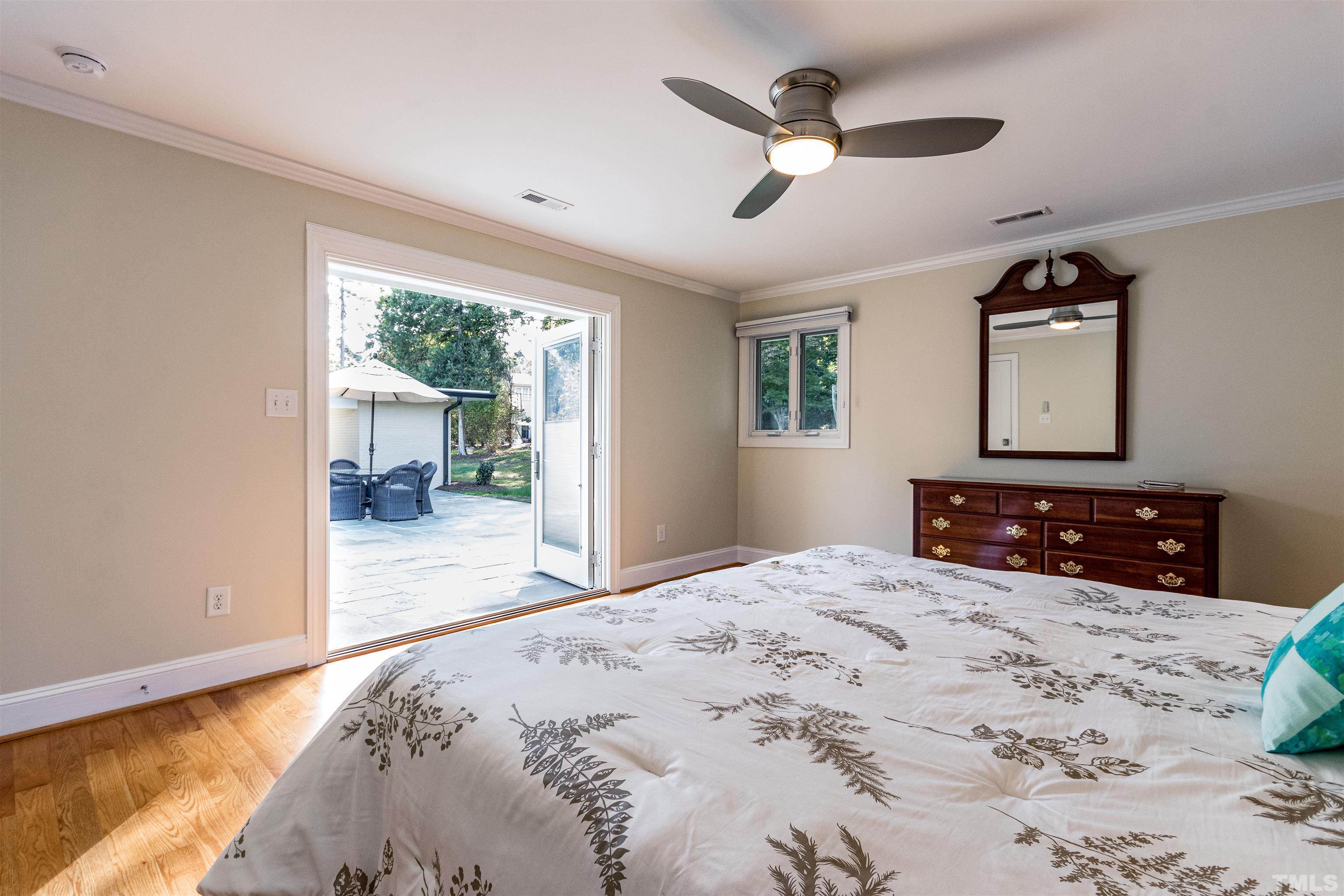 1509 Lutz Avenue Raleigh, NC 27607 - Photo 19 of 30 a bedroom with a large bed a chandelier and dresser