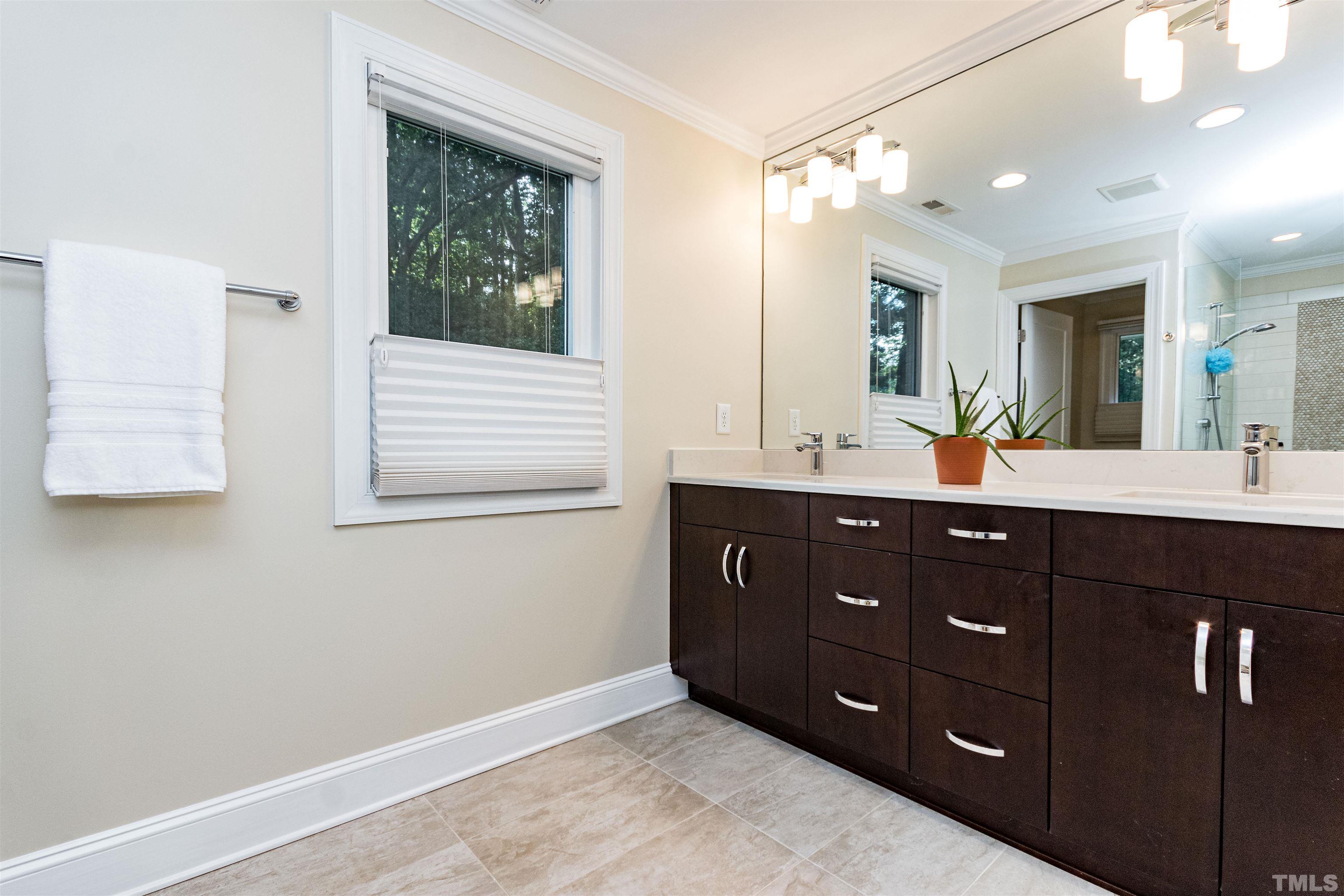 1509 Lutz Avenue Raleigh, NC 27607 - Photo 20 of 30 a bathroom with a sink double vanity and a mirror