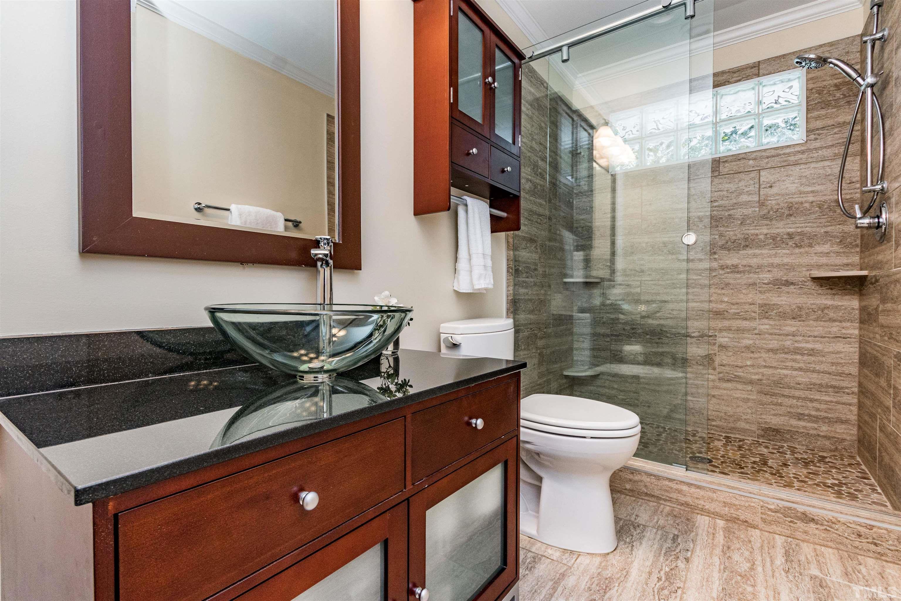 1509 Lutz Avenue Raleigh, NC 27607 - Photo 23 of 30 a bathroom with a toilet a sink and mirror