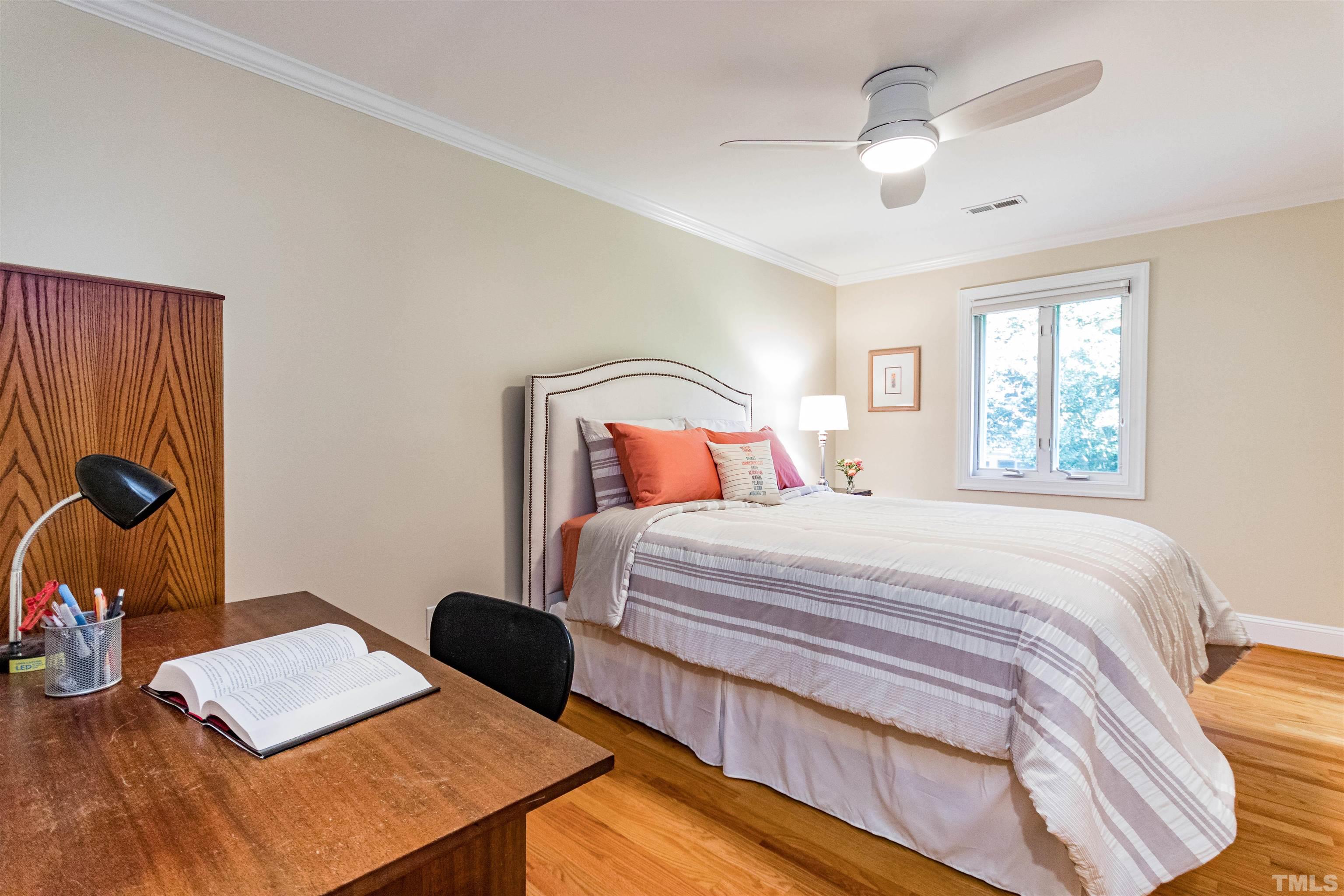 1509 Lutz Avenue Raleigh, NC 27607 - Photo 24 of 30 a bedroom with a bed and a desk