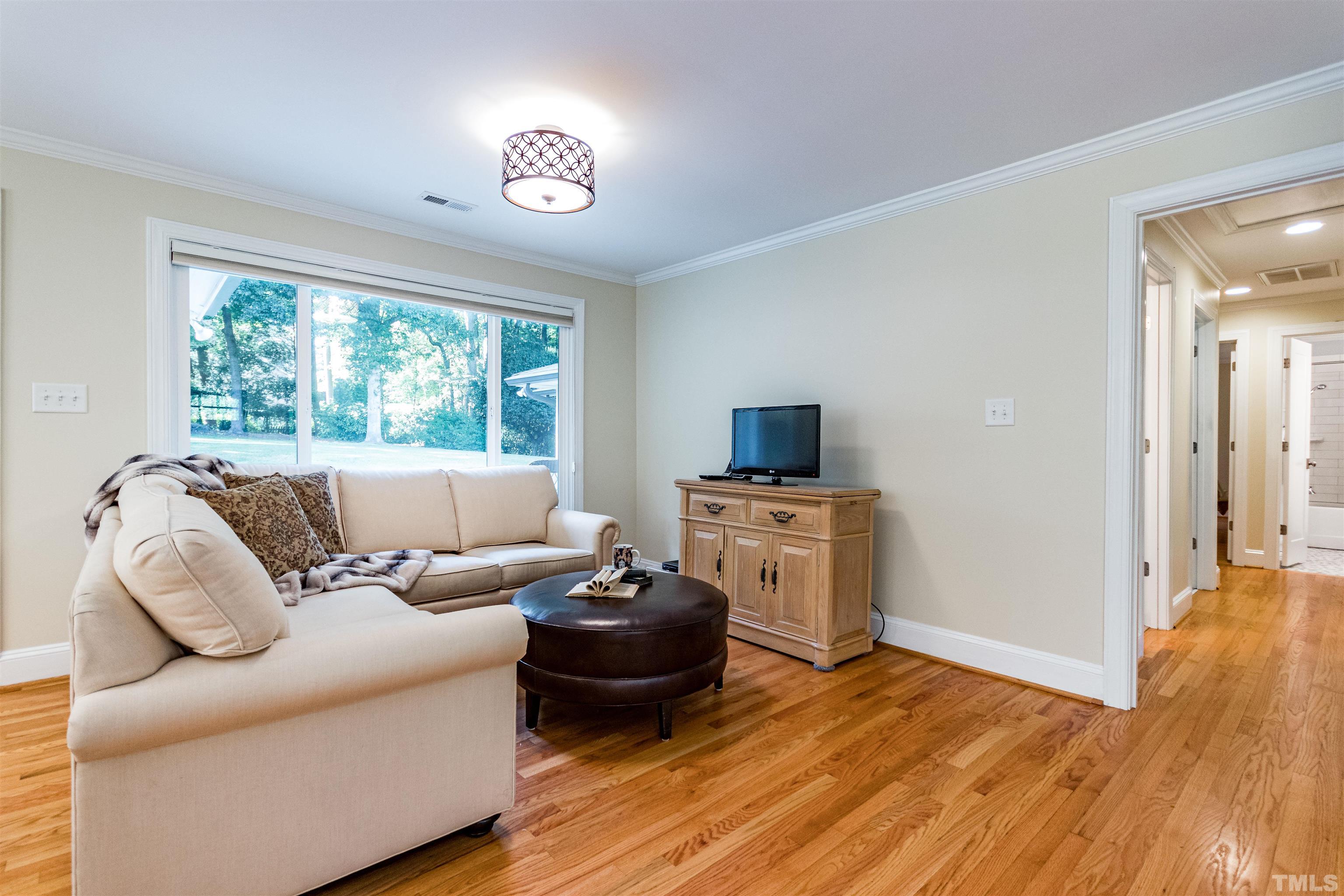 1509 Lutz Avenue Raleigh, NC 27607 - Photo 9 of 30 a living room with furniture and a flat screen tv