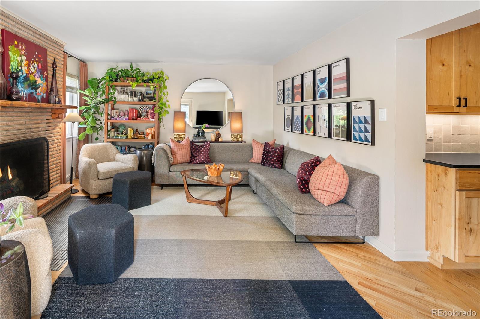 4225 Balsam Street Wheat Ridge, CO 80033 - Photo 14 of 33 a living room with furniture a fireplace and a flat screen tv