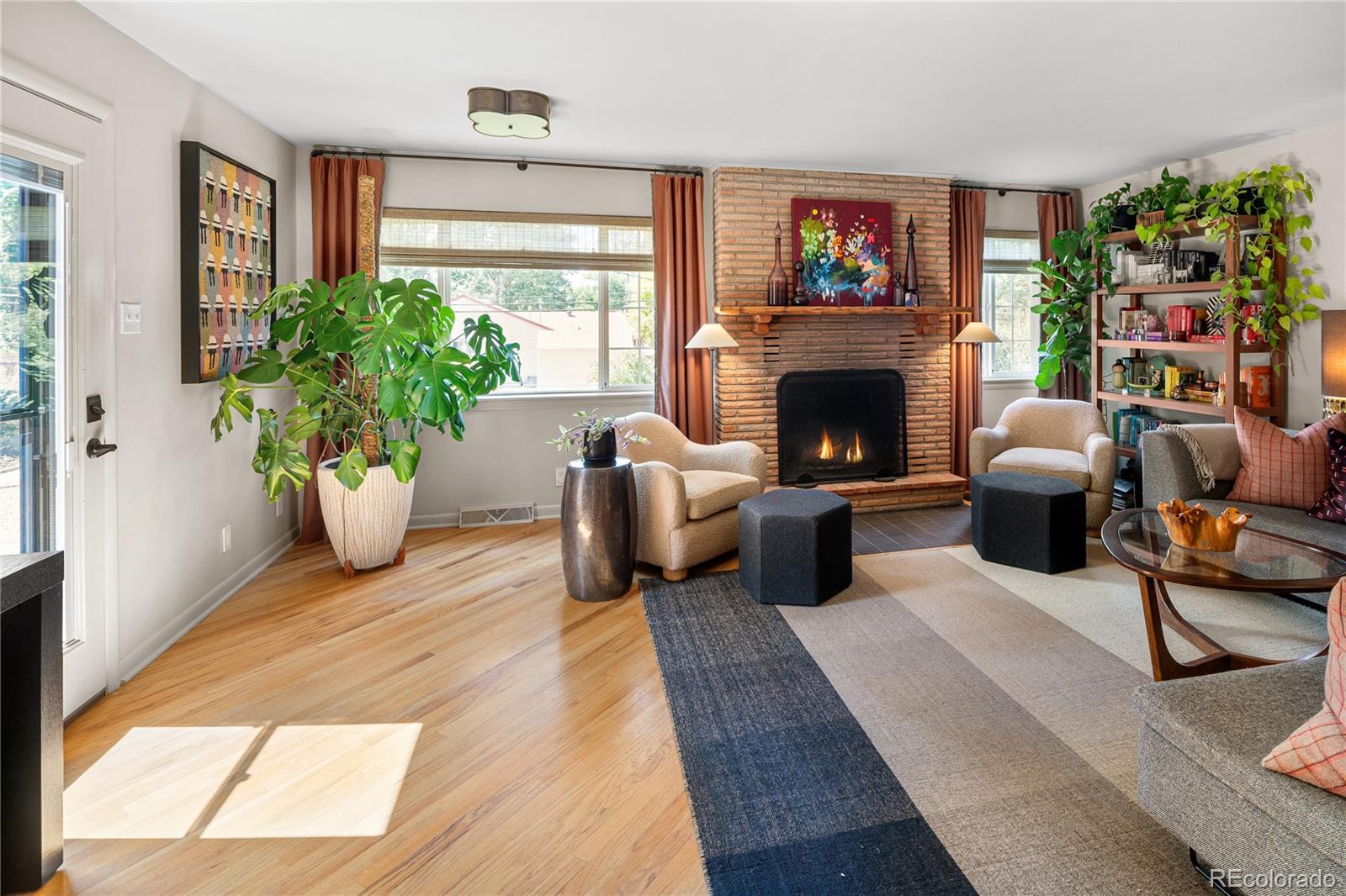 4225 Balsam Street Wheat Ridge, CO 80033 - Photo 15 of 33 a living room with furniture a fireplace and a potted plant
