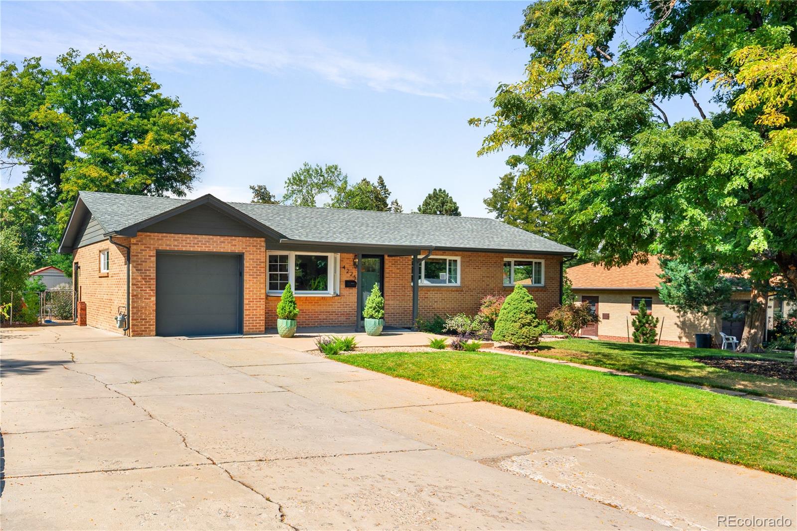 4225 Balsam Street Wheat Ridge, CO 80033 - Photo 2 of 33 a front view of a house with a yard and trees