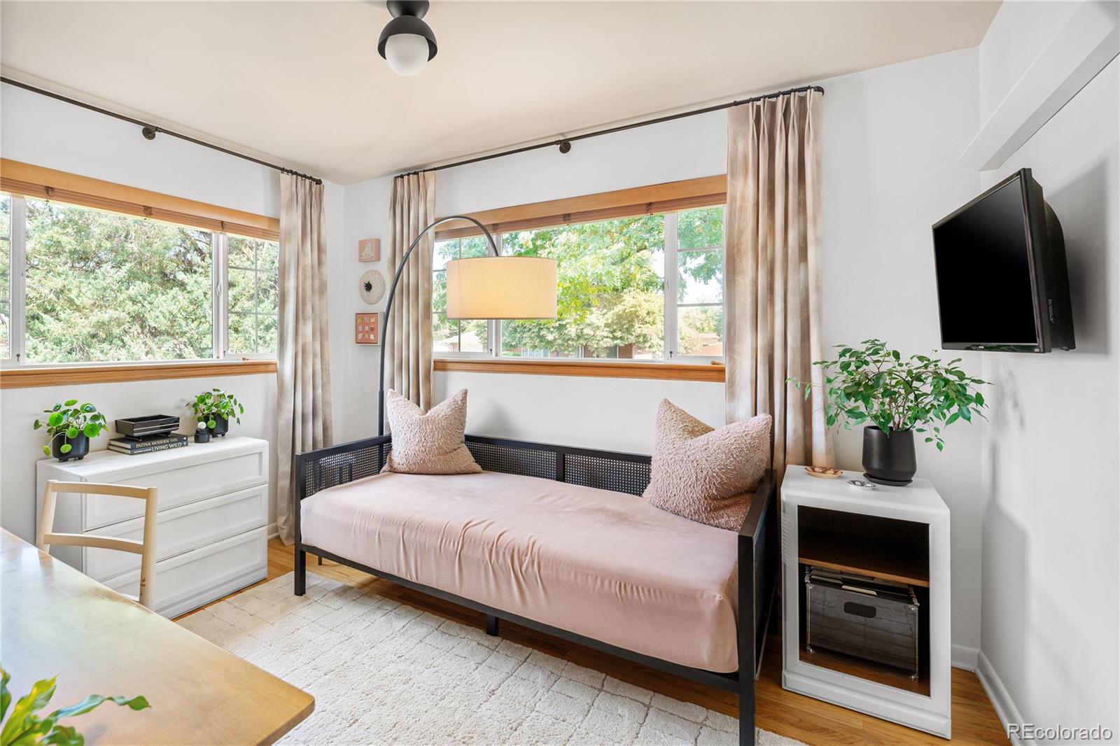 4225 Balsam Street Wheat Ridge, CO 80033 - Photo 25 of 33 a bedroom with a bed a flat screen tv and a large window