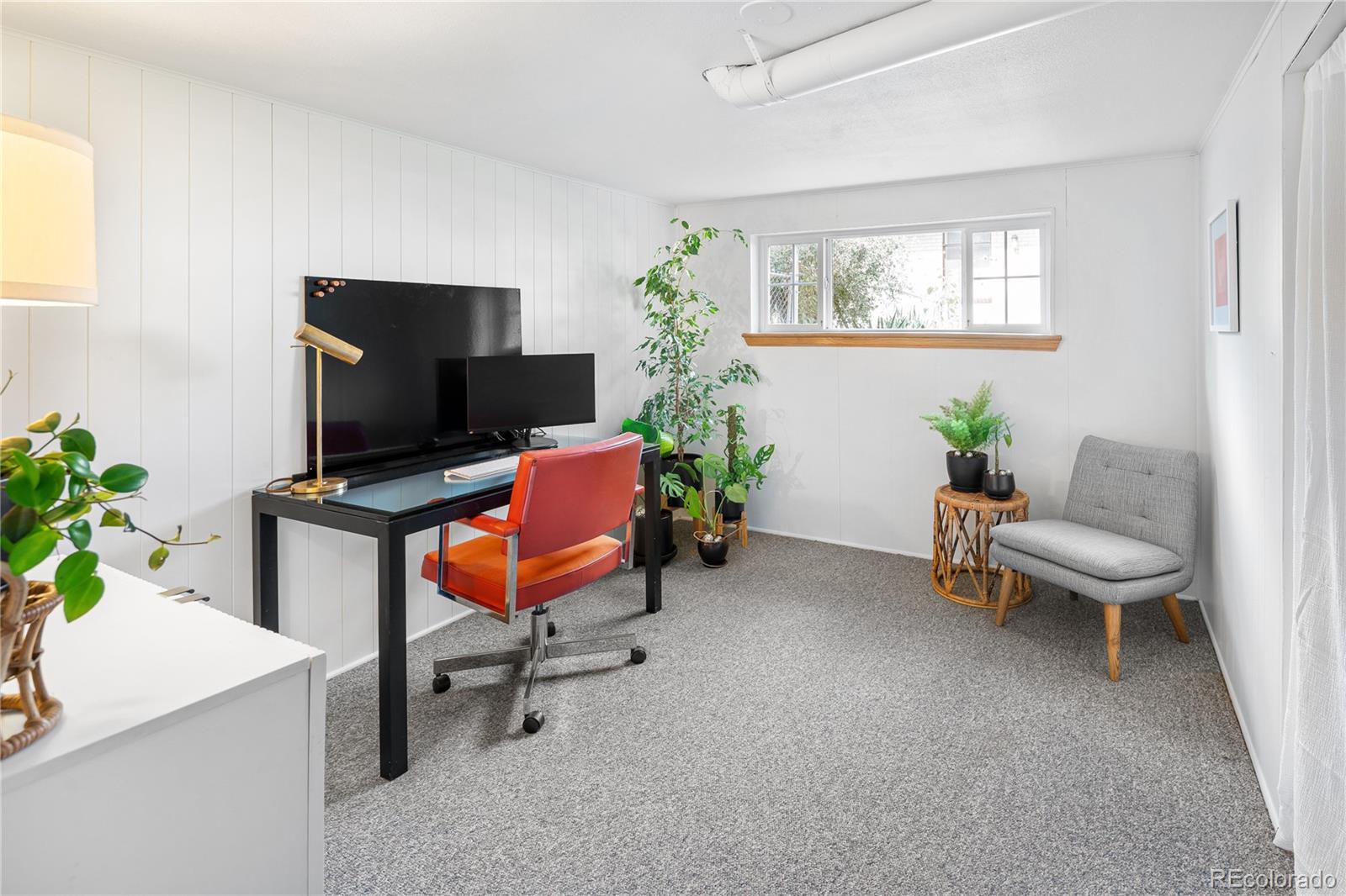4225 Balsam Street Wheat Ridge, CO 80033 - Photo 27 of 33 a living room with furniture and a flat screen tv