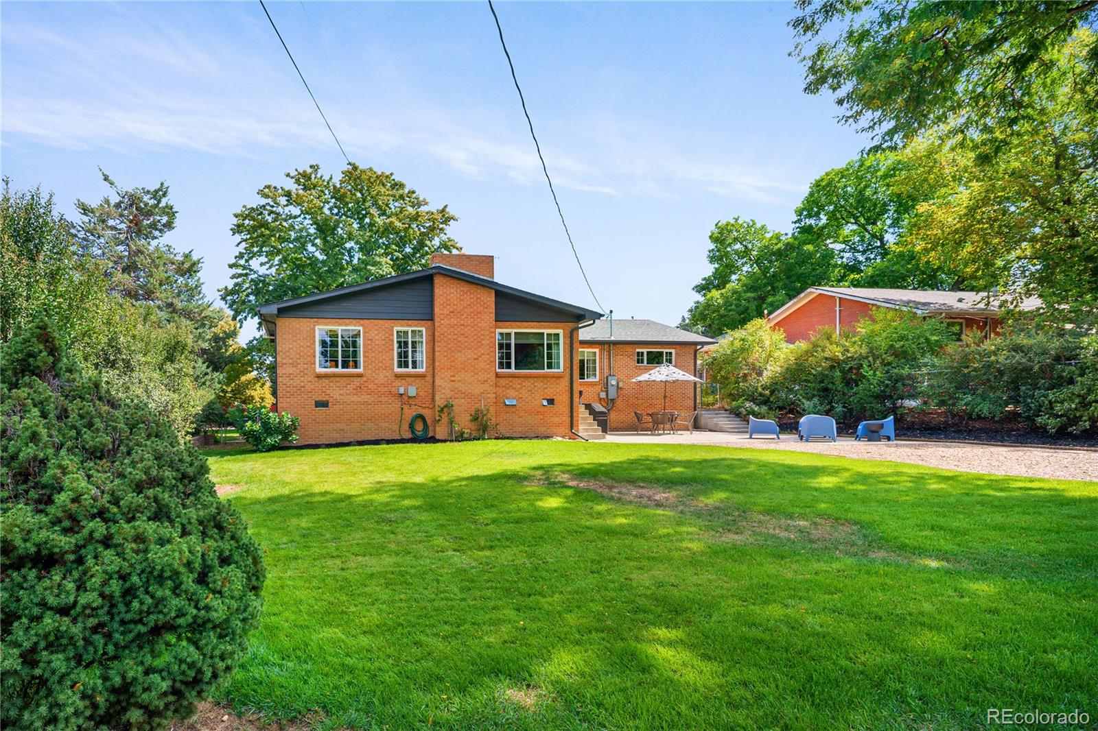 4225 Balsam Street Wheat Ridge, CO 80033 - Photo 32 of 33 a house that has a big yard plants and large trees