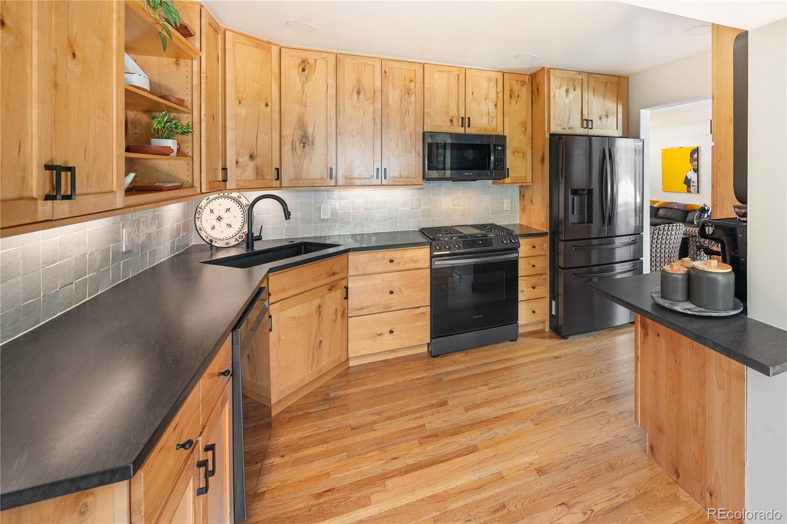 4225 Balsam Street Wheat Ridge, CO 80033 - Photo 10 of 33 a kitchen with stainless steel appliances granite countertop a refrigerator a stove top oven a sink and dishwasher