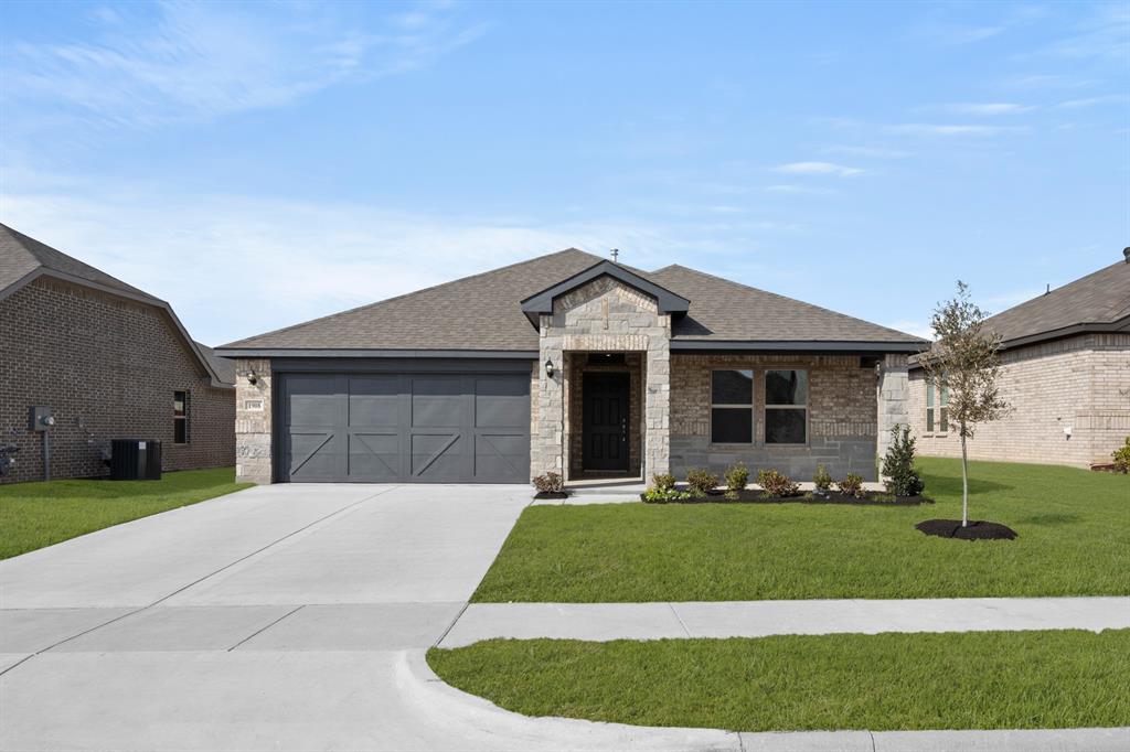 1908 Seminole Drive Cleburne, TX 76033 - Photo 1 of 27 a front view of a house with a yard and garage