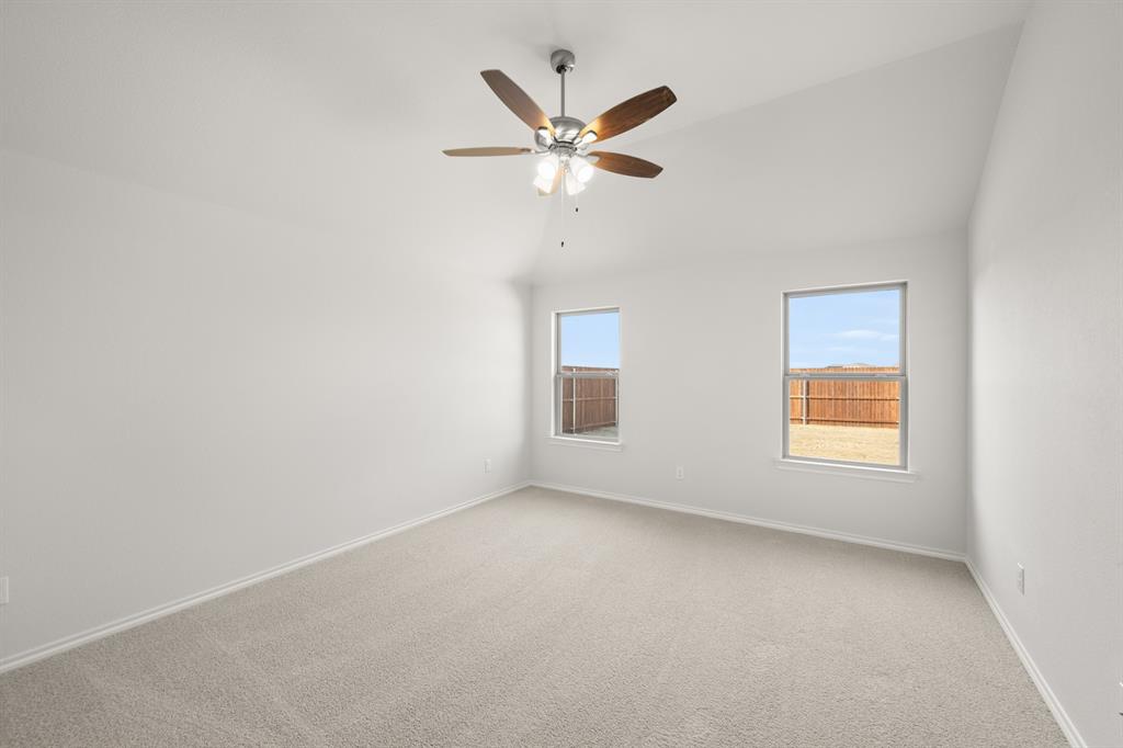 1908 Seminole Drive Cleburne, TX 76033 - Photo 18 of 27 an empty room with window and ceiling fan