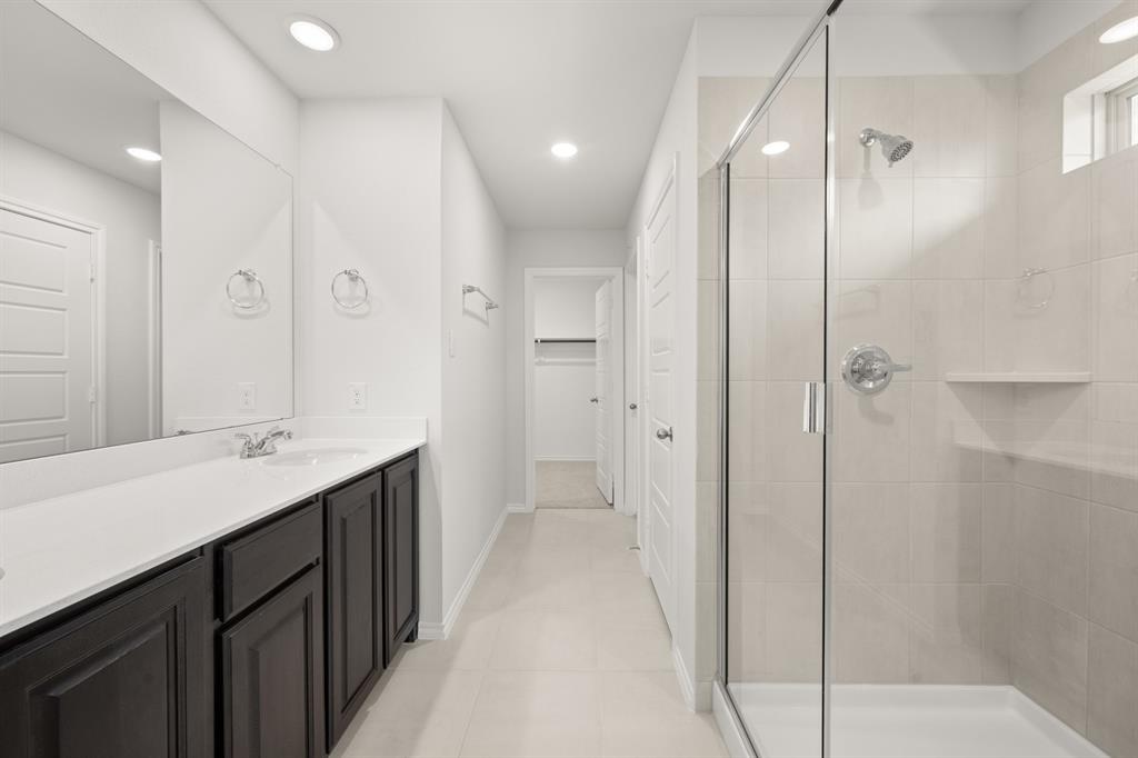 1908 Seminole Drive Cleburne, TX 76033 - Photo 20 of 27 a bathroom with a double vanity sink mirror and shower