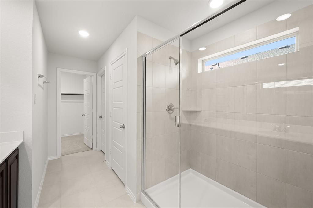 1908 Seminole Drive Cleburne, TX 76033 - Photo 23 of 27 a bathroom with a shower and a glass door