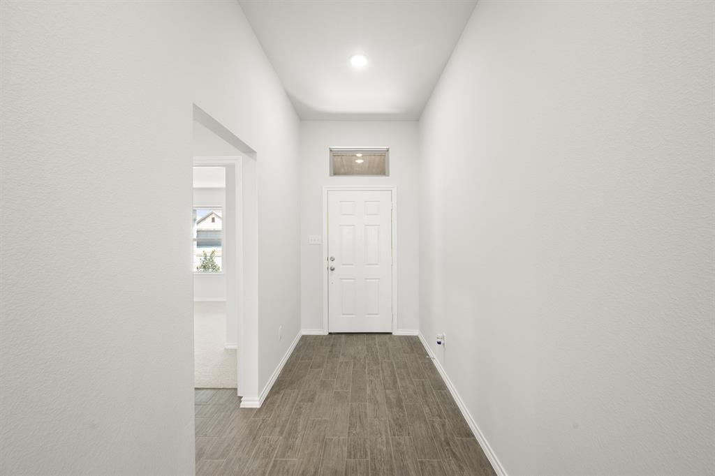 1908 Seminole Drive Cleburne, TX 76033 - Photo 3 of 27 a view of a hallway with wooden floor