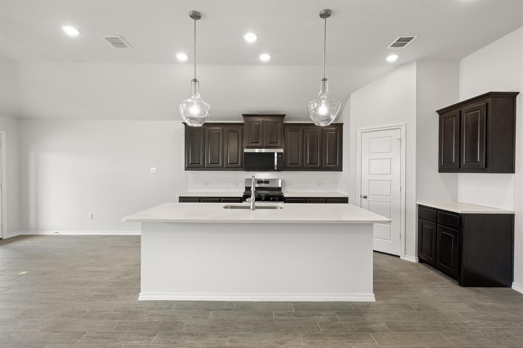 1908 Seminole Drive Cleburne, TX 76033 - Photo 4 of 27 a kitchen with kitchen island a sink stainless steel appliances and kitchen island