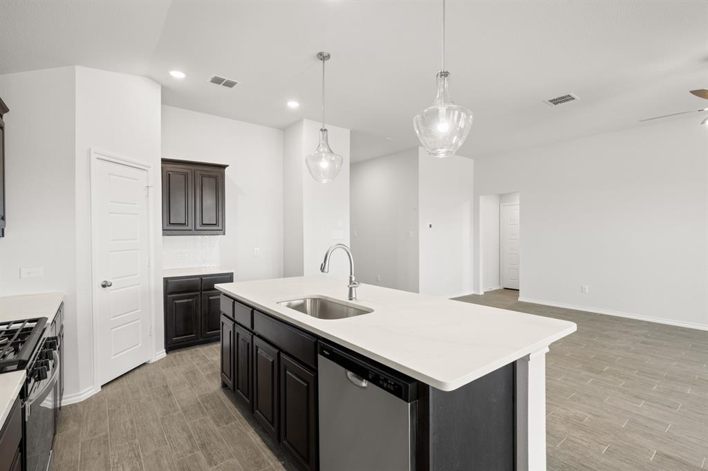 1908 Seminole Drive Cleburne, TX 76033 - Photo 8 of 27 a kitchen with a sink center island and a stove