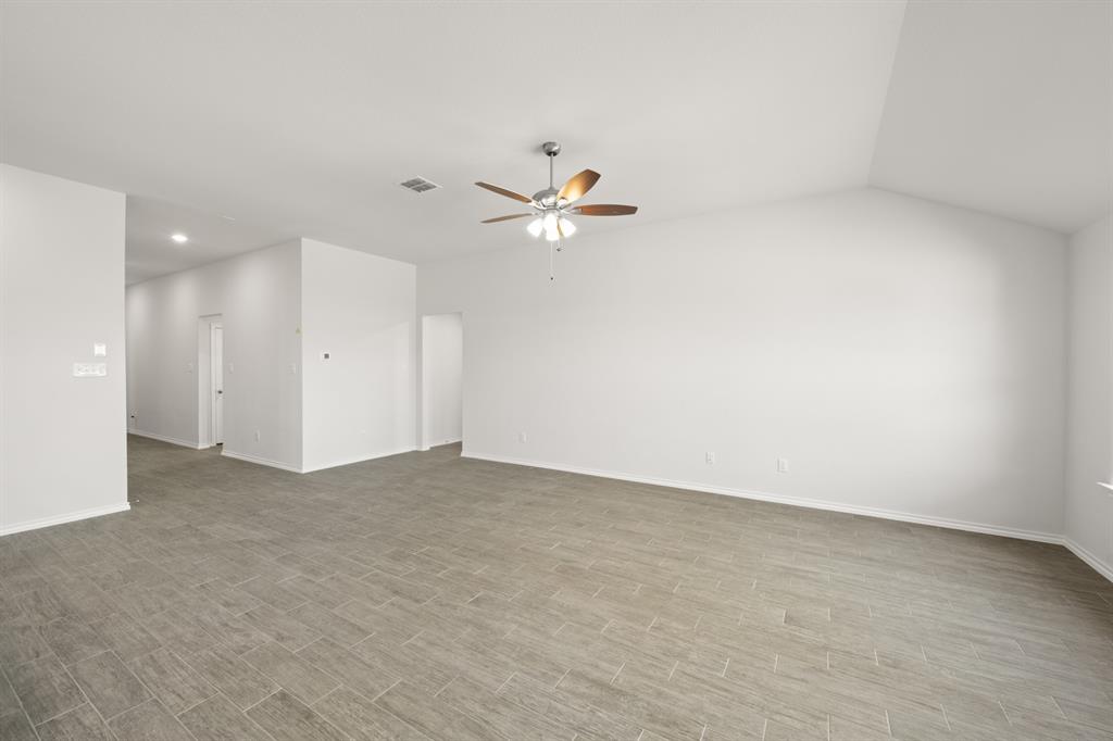 1908 Seminole Drive Cleburne, TX 76033 - Photo 10 of 27 an empty room with fan and a ceiling fan