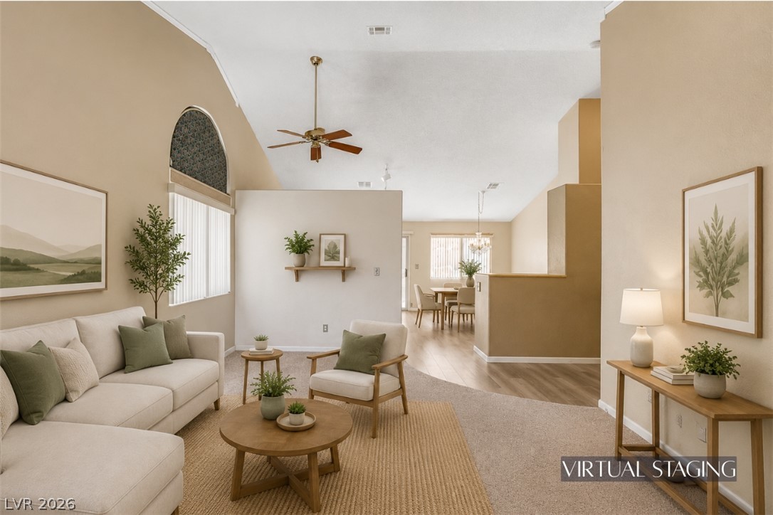 Vaulted ceilings soar over this airy living space transitioning into the dining area.