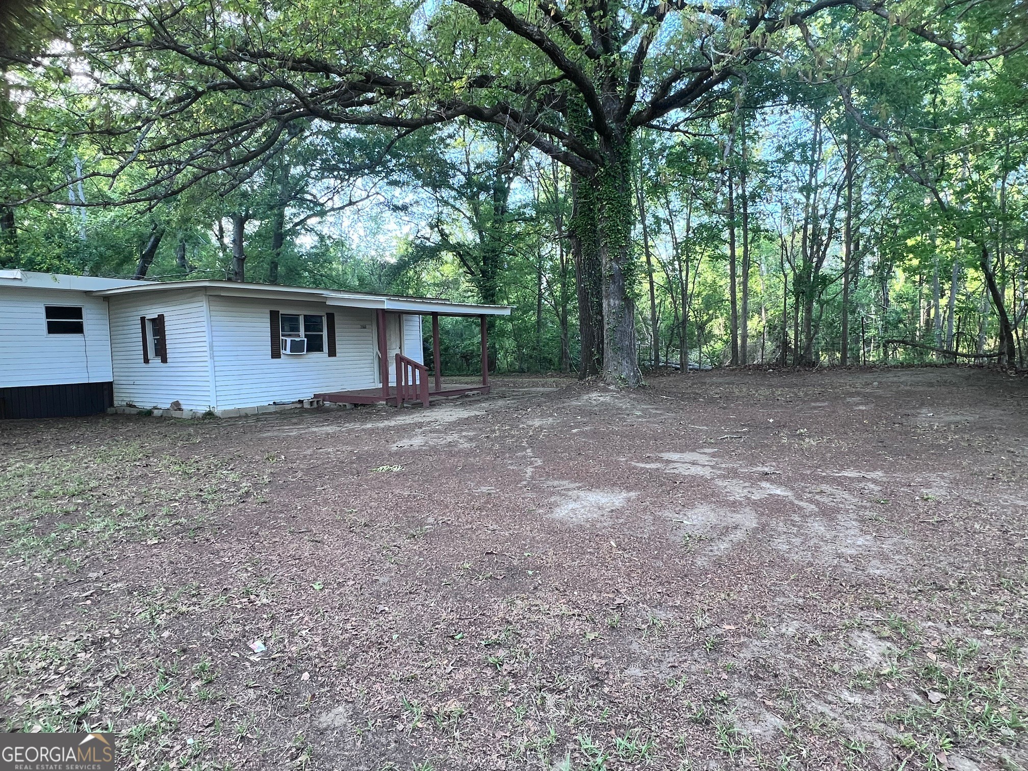 3195 Henderson Grove Road Sandersville, GA 31082 - Photo 25 of 50 a view of a house with yard and a tree