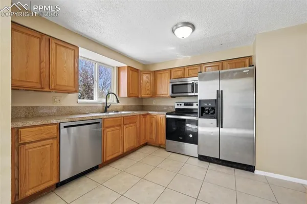 a bedroom with bed and wall painting