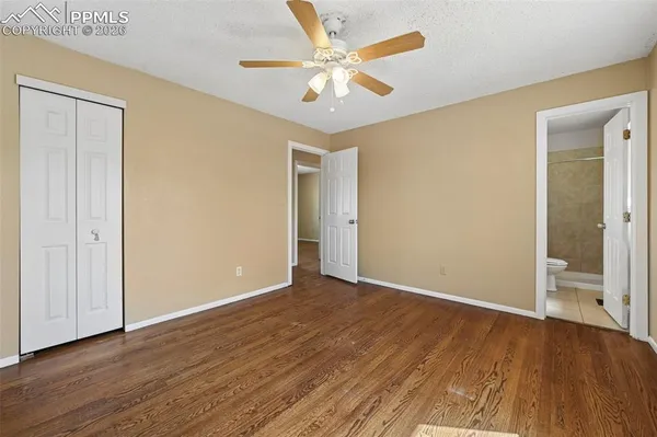 a spacious bedroom with a large bed and a flat screen tv