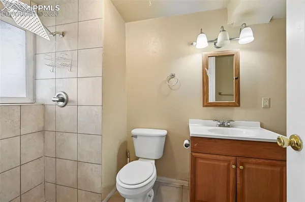 a bedroom with a bed potted plant and a window