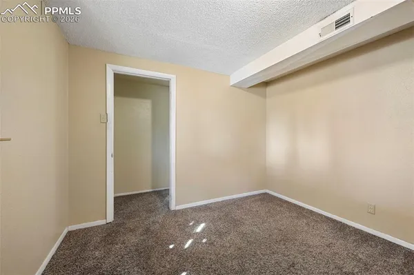 a bedroom with a large bed and a potted plant