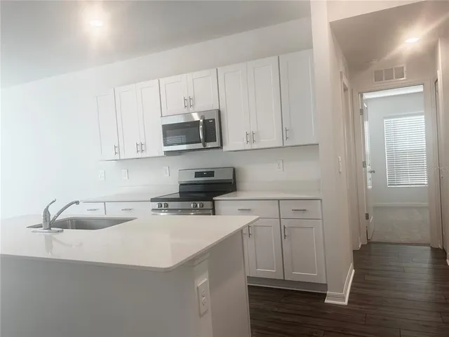 a stove top oven sitting inside of a kitchen
