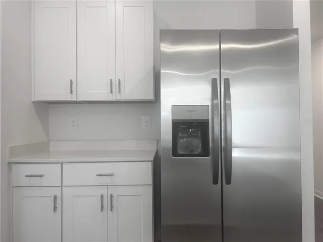 an empty room with a window and ceiling fan