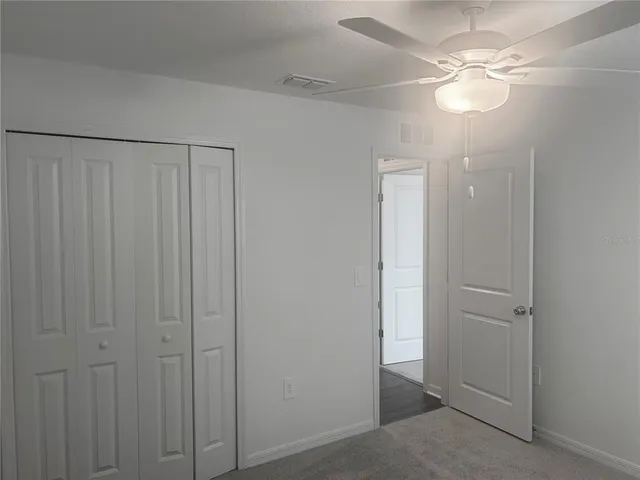a bathroom with a granite countertop toilet a sink and shower