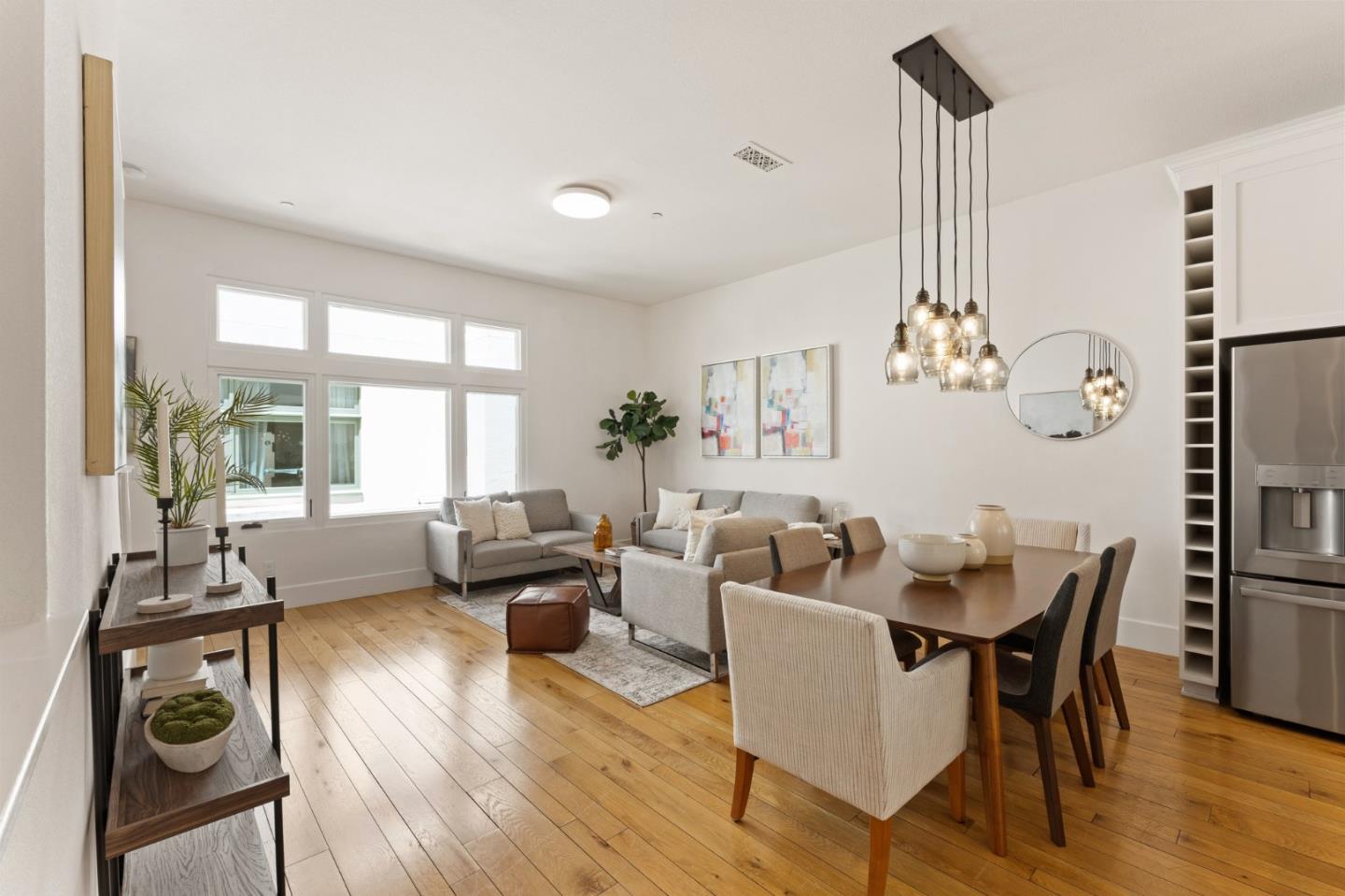 533 Fierro Loop Campbell, CA 95008 - Photo 15 of 62 a living room with furniture a chandelier and wooden floor