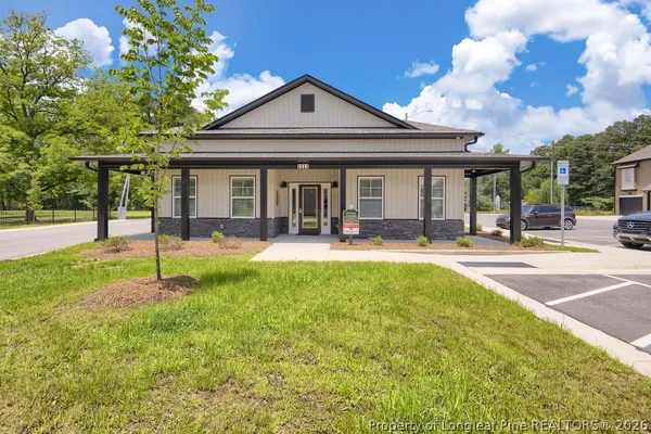 a front view of a house with a garden