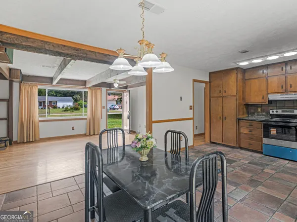 a dining room with furniture and window