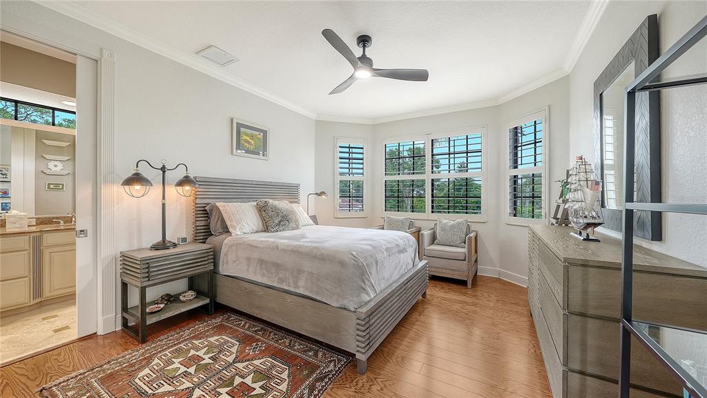1630 Assisi Drive, Unit 18 Sarasota, FL 34231 - Photo 28 of 42 a bedroom with a bed and a large window