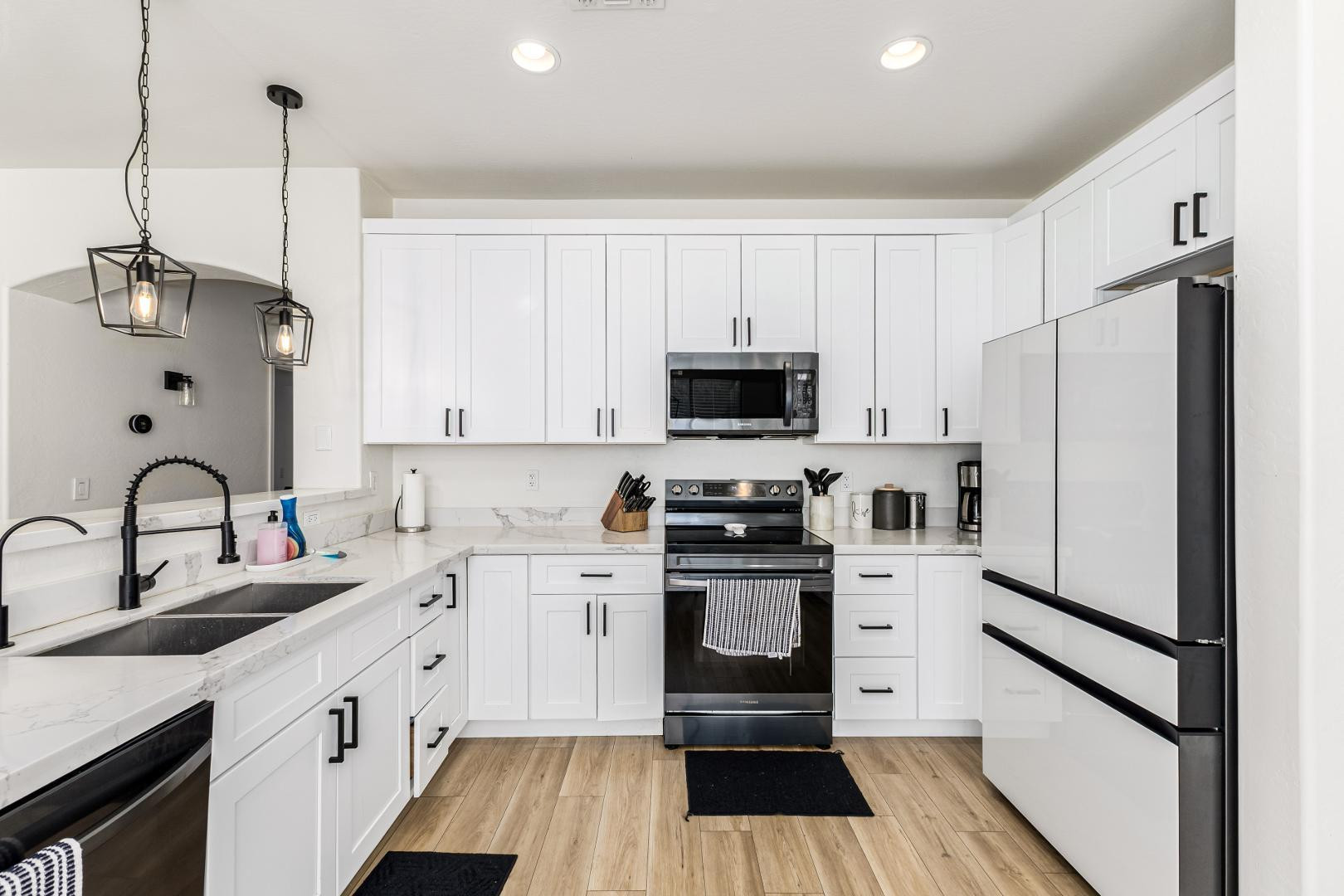 2707 West Lamar Road Phoenix, AZ 85017 - Photo 44 of 44 a kitchen with white cabinets stainless steel appliances and a counter space