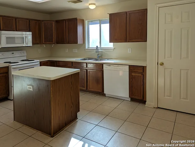 a kitchen with a cabinets sink and window
