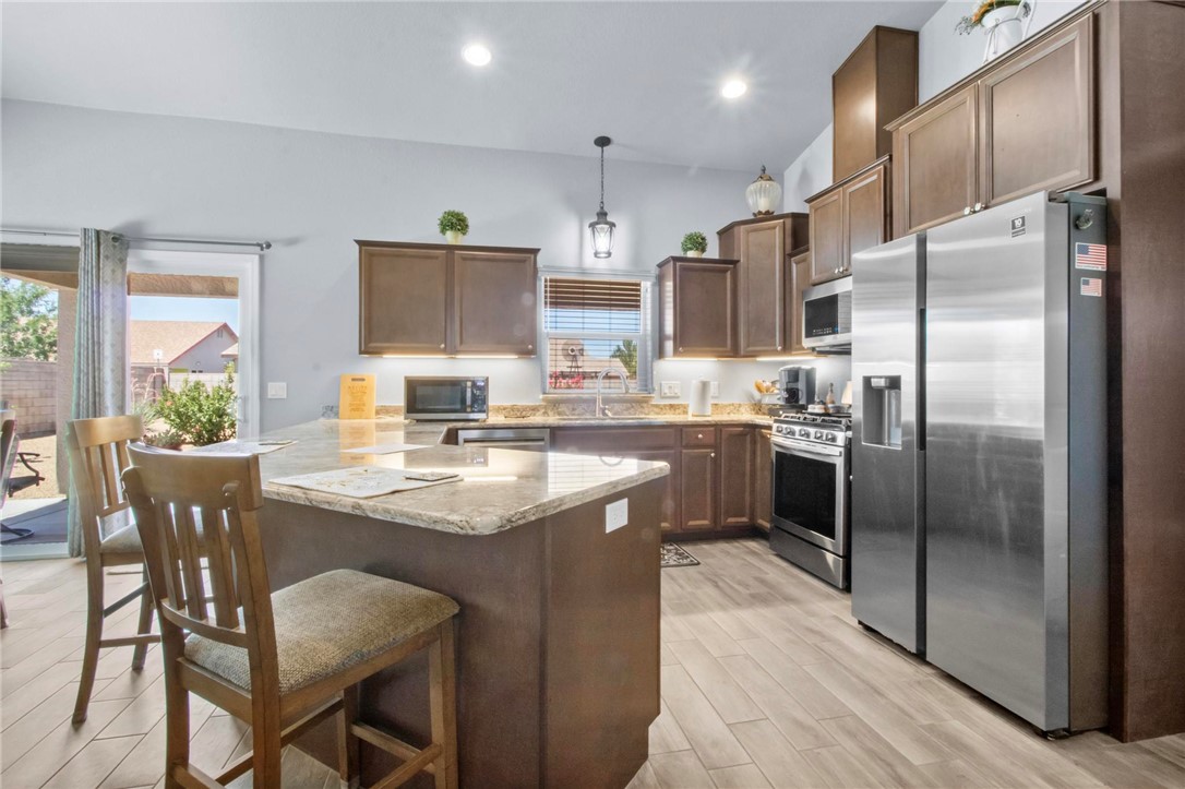 3897 Easy Street Kingman, AZ 86409 - Photo 10 of 53 a kitchen with stainless steel appliances granite countertop a sink refrigerator and cabinets