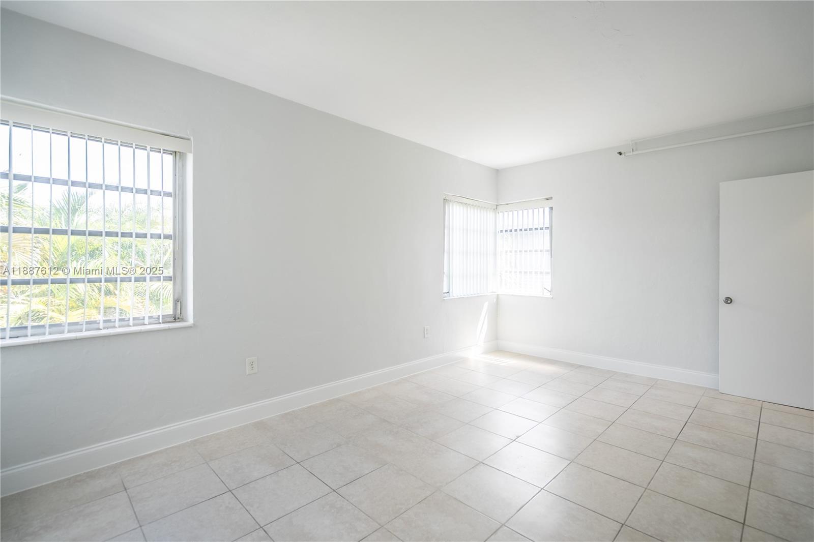 8300 Abbott Avenue, Unit 17 Miami Beach, FL 33141 - Photo 11 of 16 a view of an empty room with a window
