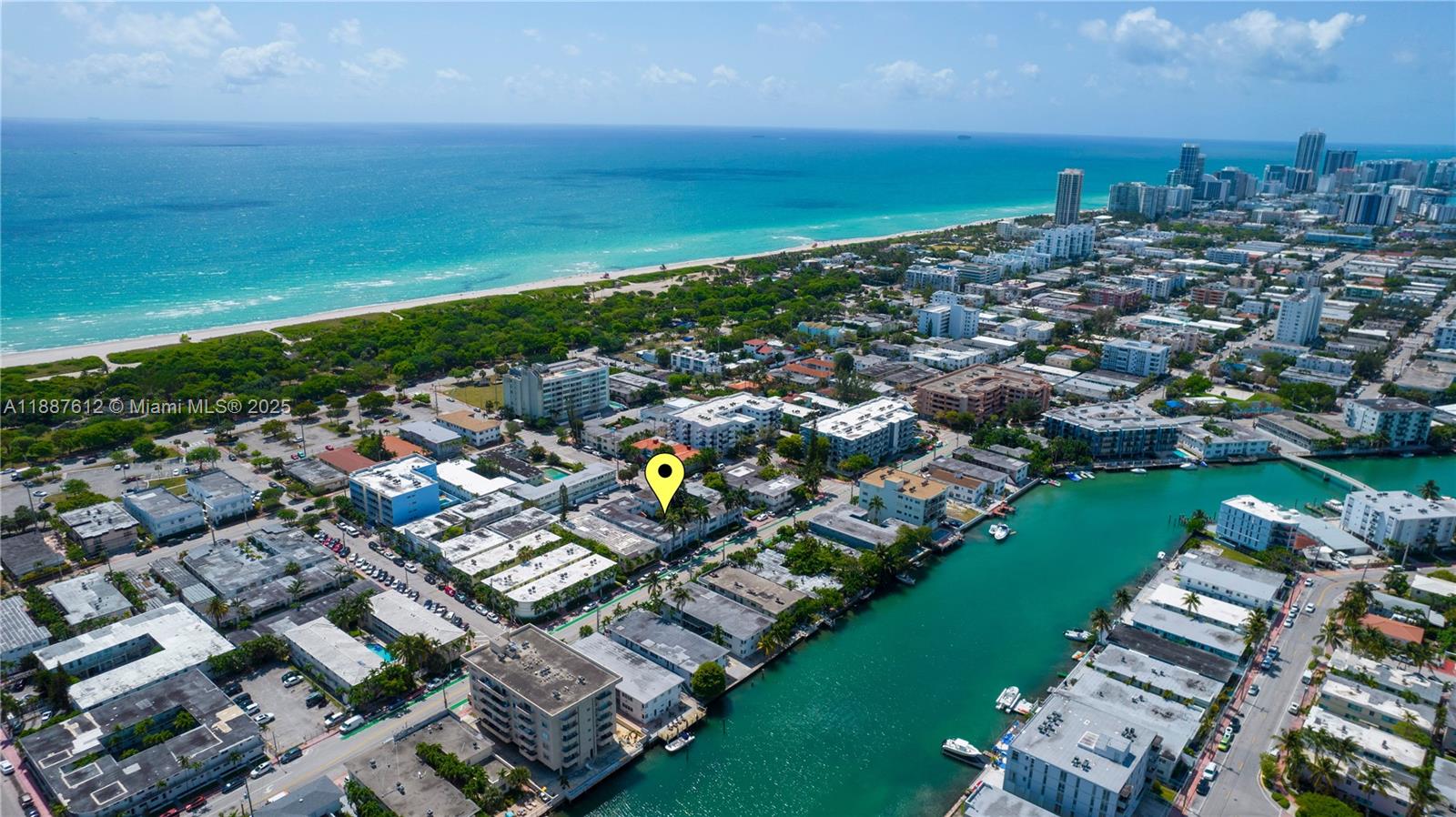 8300 Abbott Avenue, Unit 17 Miami Beach, FL 33141 - Photo 16 of 16 an aerial view of a city with lots of residential buildings ocean and mountain view in back