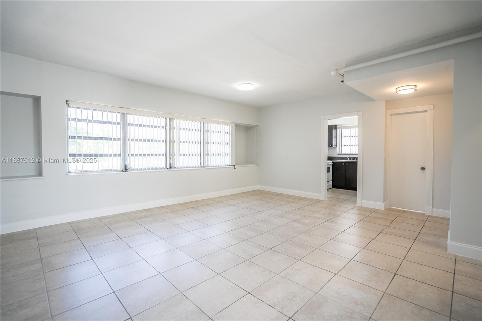 8300 Abbott Avenue, Unit 17 Miami Beach, FL 33141 - Photo 2 of 16 a view of an empty room with a window