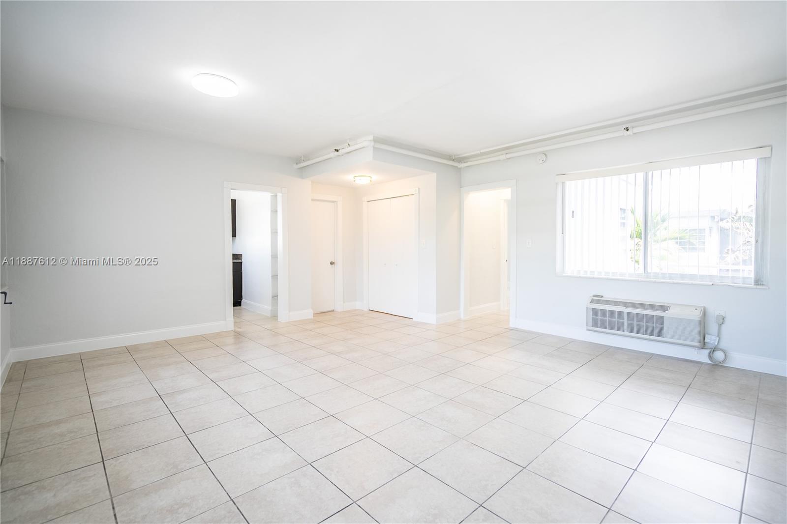 8300 Abbott Avenue, Unit 17 Miami Beach, FL 33141 - Photo 3 of 16 a view of an empty room with a window