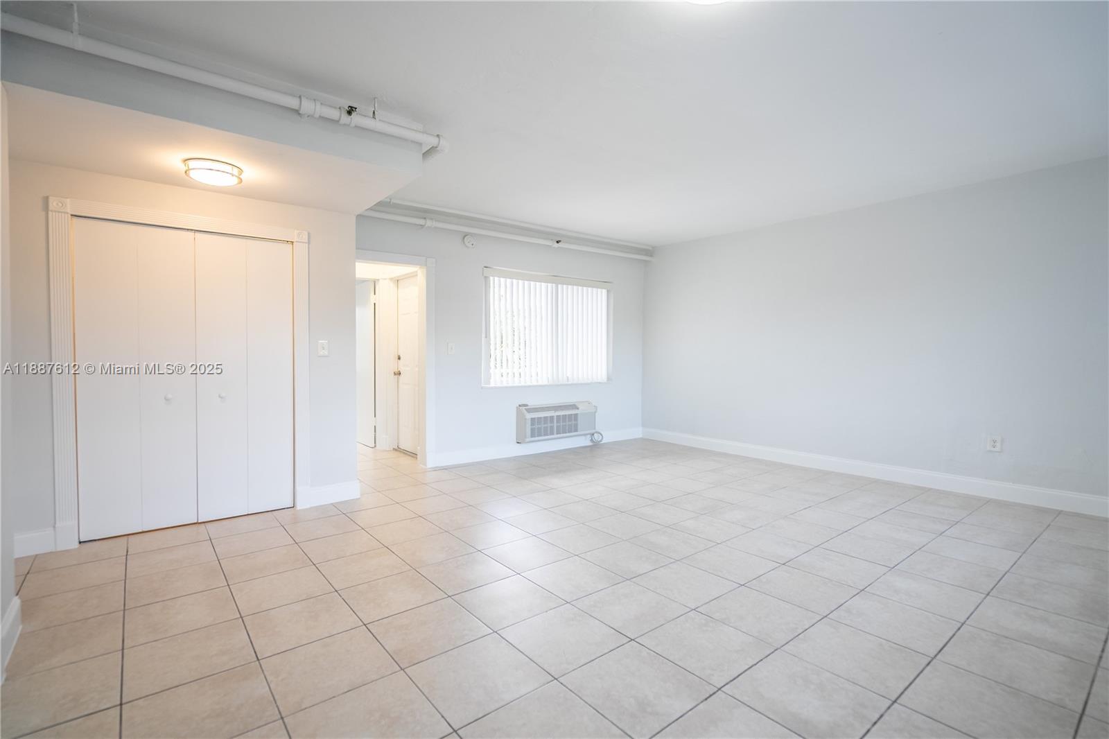 8300 Abbott Avenue, Unit 17 Miami Beach, FL 33141 - Photo 4 of 16 a view of an empty room and window