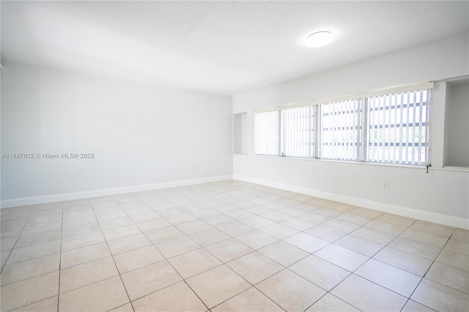 8300 Abbott Avenue, Unit 17 Miami Beach, FL 33141 - Photo 5 of 16 an empty room with windows