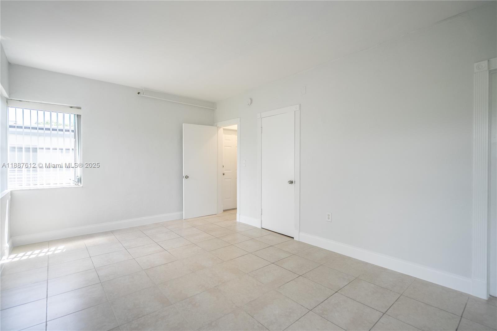 8300 Abbott Avenue, Unit 17 Miami Beach, FL 33141 - Photo 10 of 16 an empty room with windows