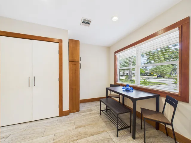 a spacious bathroom with a granite countertop sink mirror and a bathtub