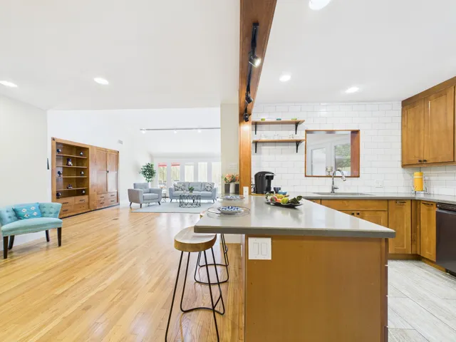a dining room with furniture and a window