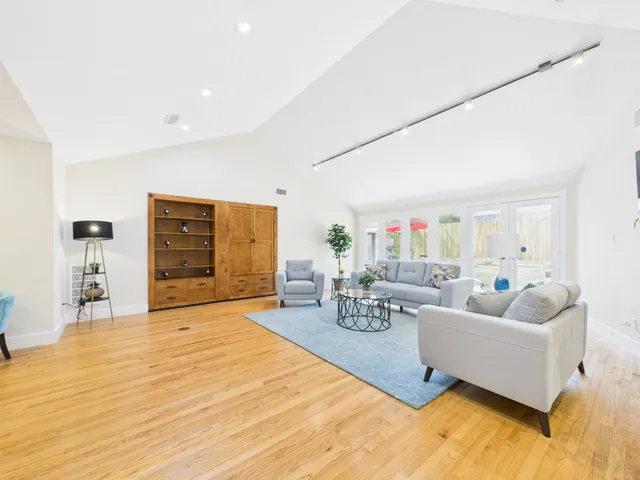 a kitchen with sink and view of living room