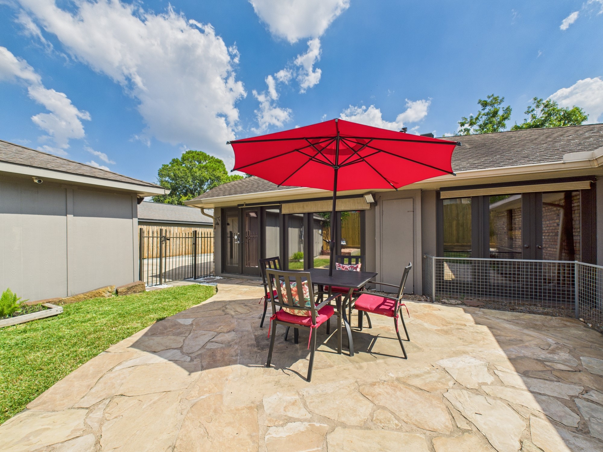 2432 Chimney Rock Road Houston, TX 77057 - Photo 20 of 43 a view of a patio with a table and chairs under an umbrella